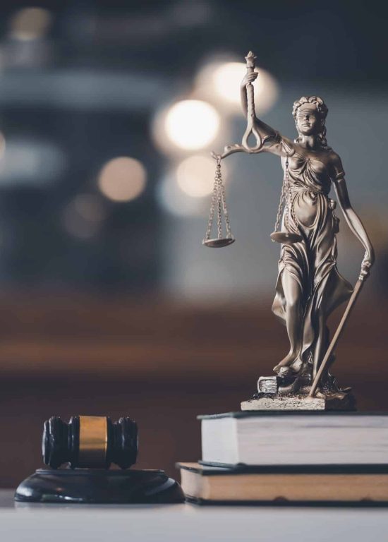 Statue of lady justice on desk of a judge or lawyer.